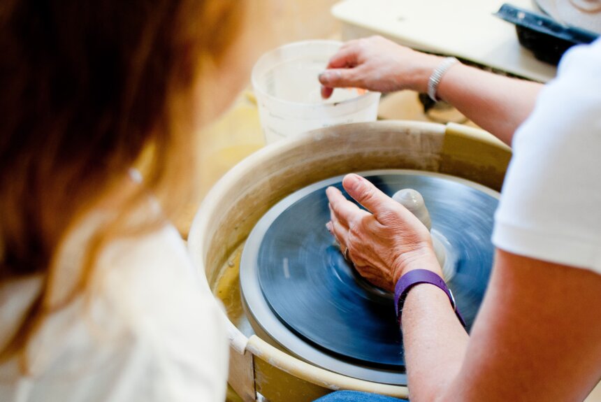 Person making pottery on a wheel